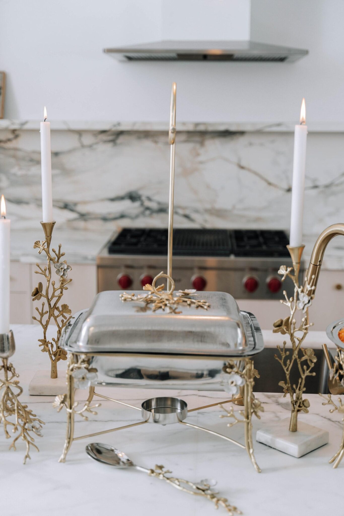 Orchid chafing dish with matching candle holders and serving pieces on a table